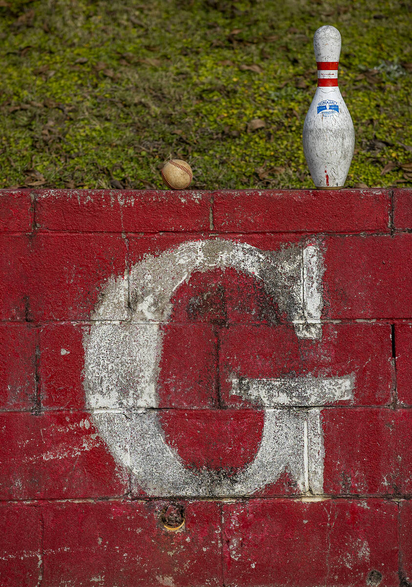 A baseball and bowling pin left on top of a wall near the football field at Robert E. Lee High ...
