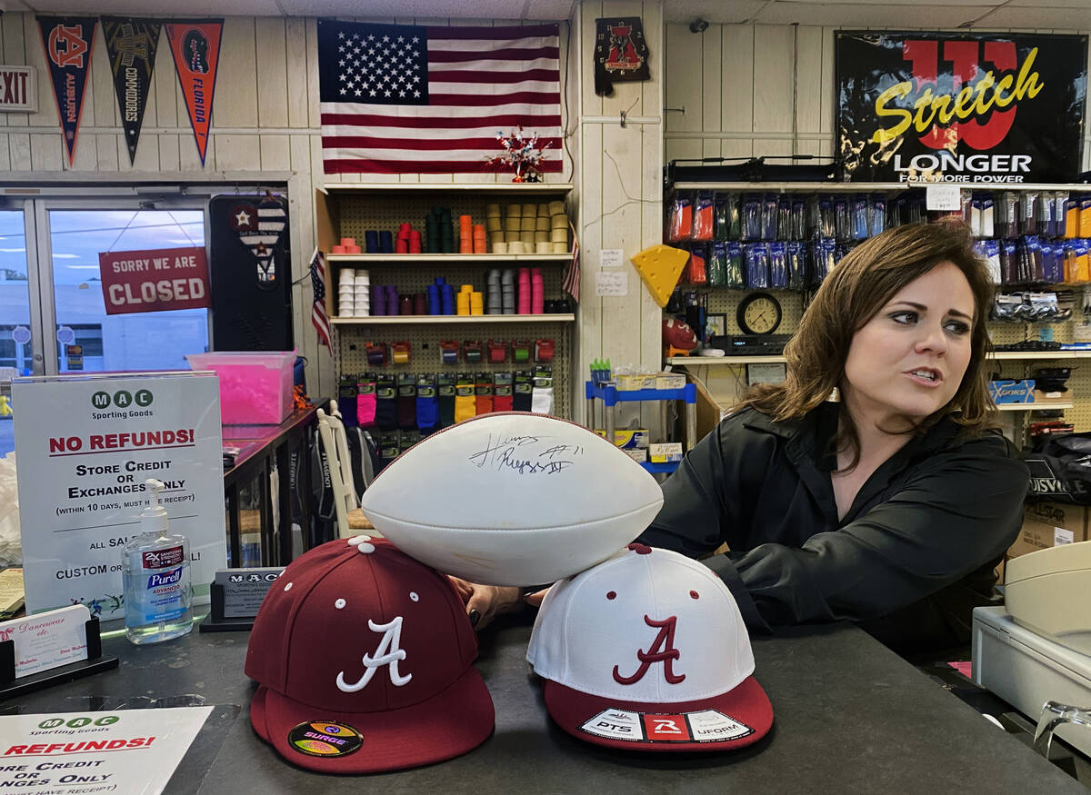 Stacie Mclendon of the Mclendon Athletic Center shows of a signed football given to them by Hen ...