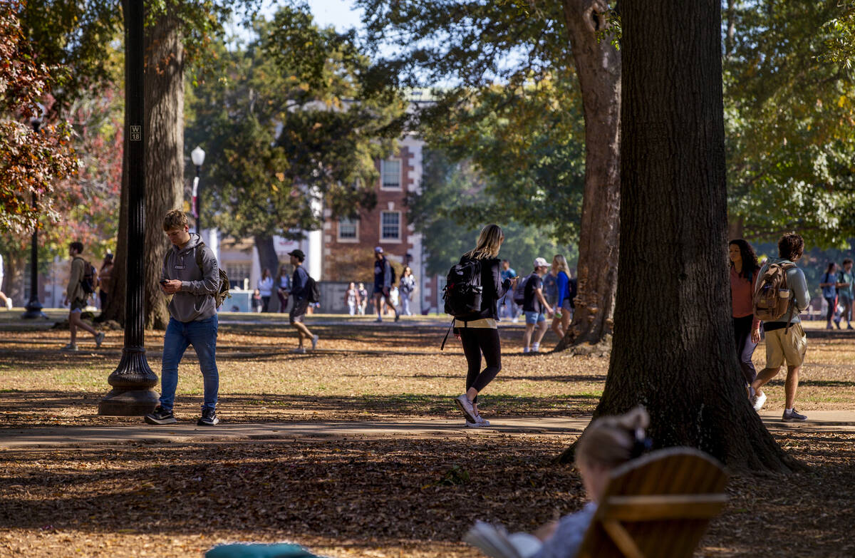 Students walk about the grounds of the University of Alabama on Wednesday, Nov. 10, 2021, in Tu ...