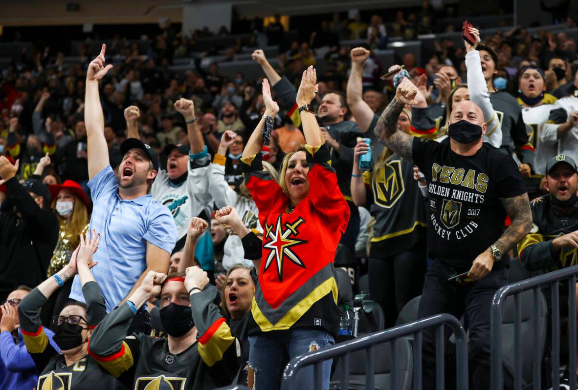 Golden Knights fans celebrate after a series of saves by Golden Knights goaltender Laurent Bros ...