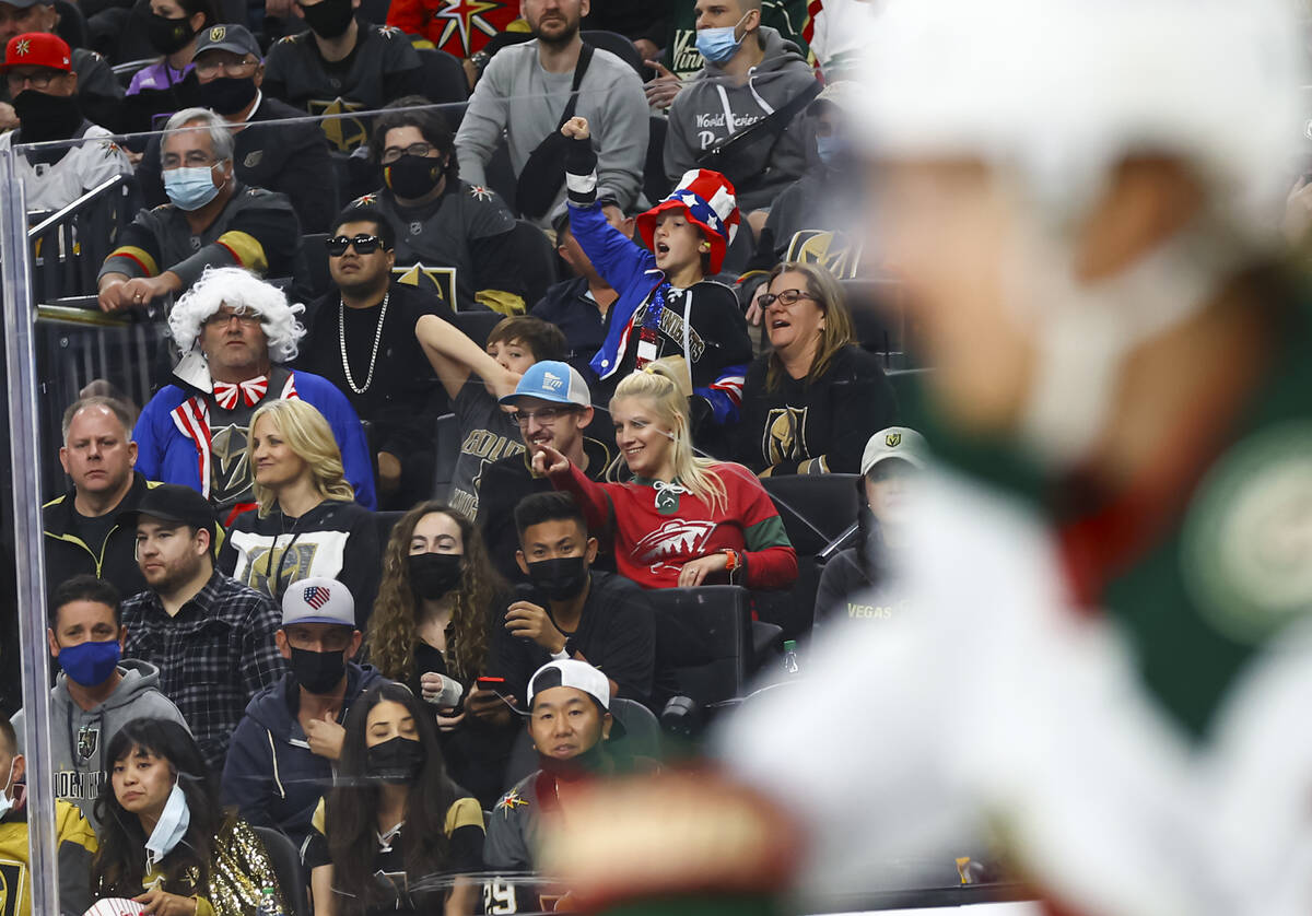 Golden Knights fans cheer during the first period of an NHL hockey game against the Minnesota W ...