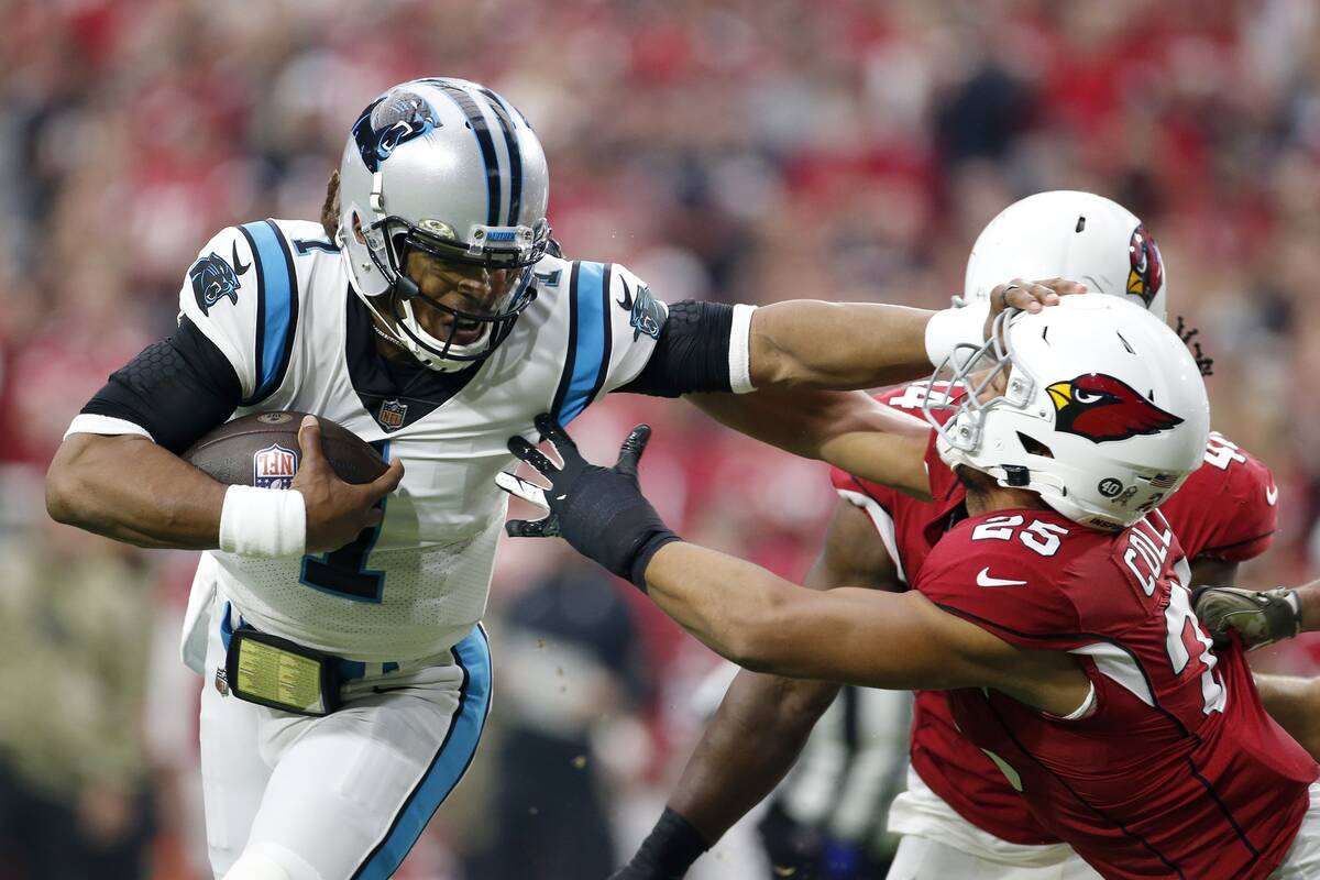 Carolina Panthers quarterback Cam Newton (1) gives Arizona Cardinals inside linebacker Zaven Co ...