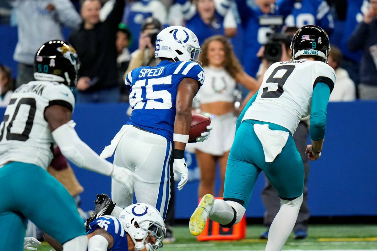 Indianapolis Colts linebacker E.J. Speed (45) runs in for a touchdown after recovering a blocke ...