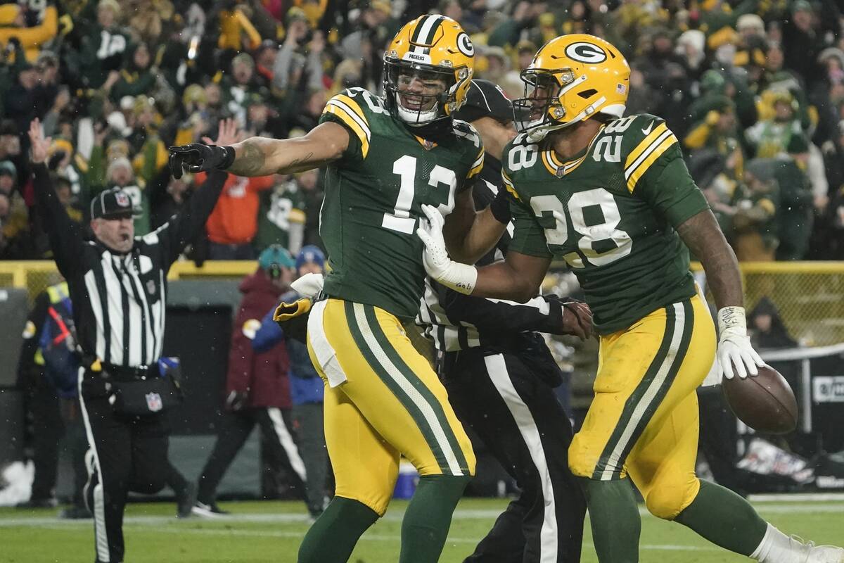 Green Bay Packers' AJ Dillon celebrates his touchdown run with Allen Lazard during the second h ...