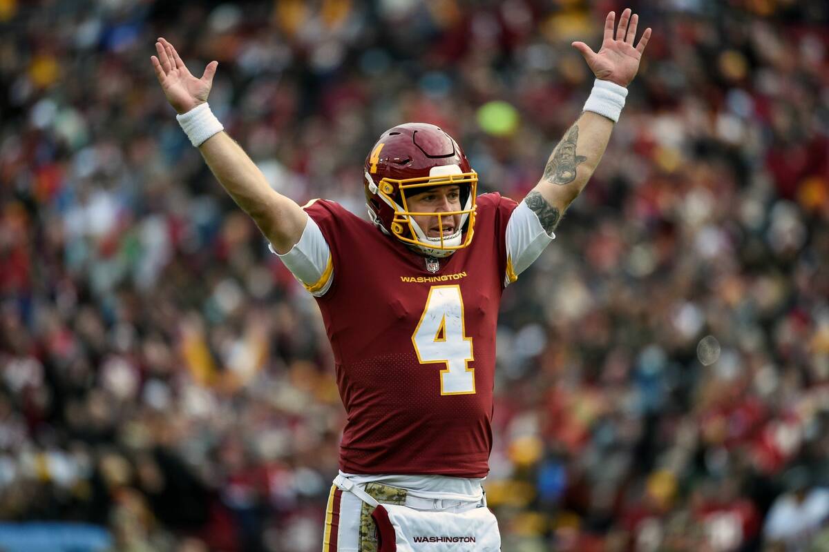 Washington Football Team quarterback Taylor Heinicke celebrates a touchdown by running back Ant ...