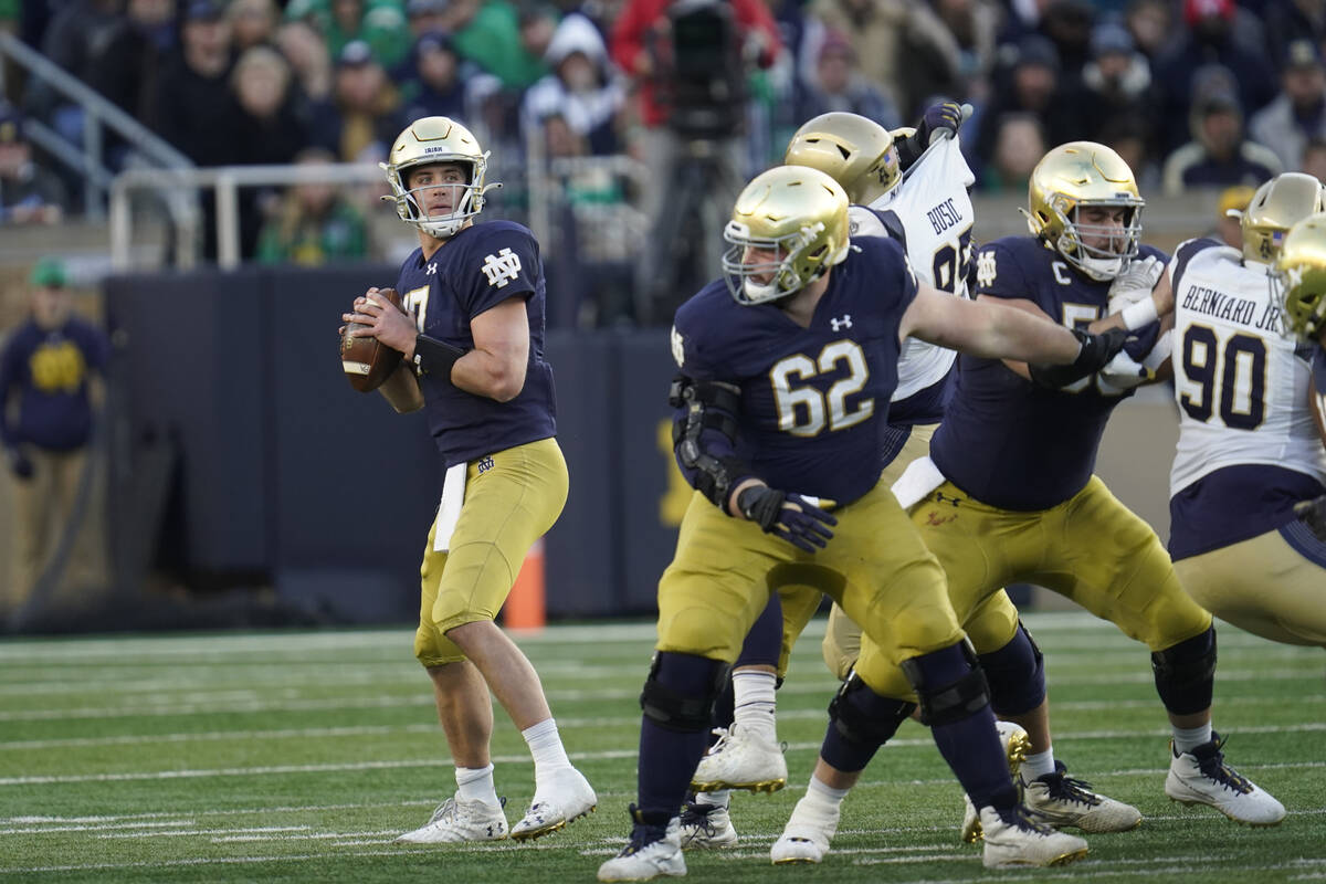 Notre Dame quarterback Jack Coan (17) throws against Navy in the second half of an NCAA college ...