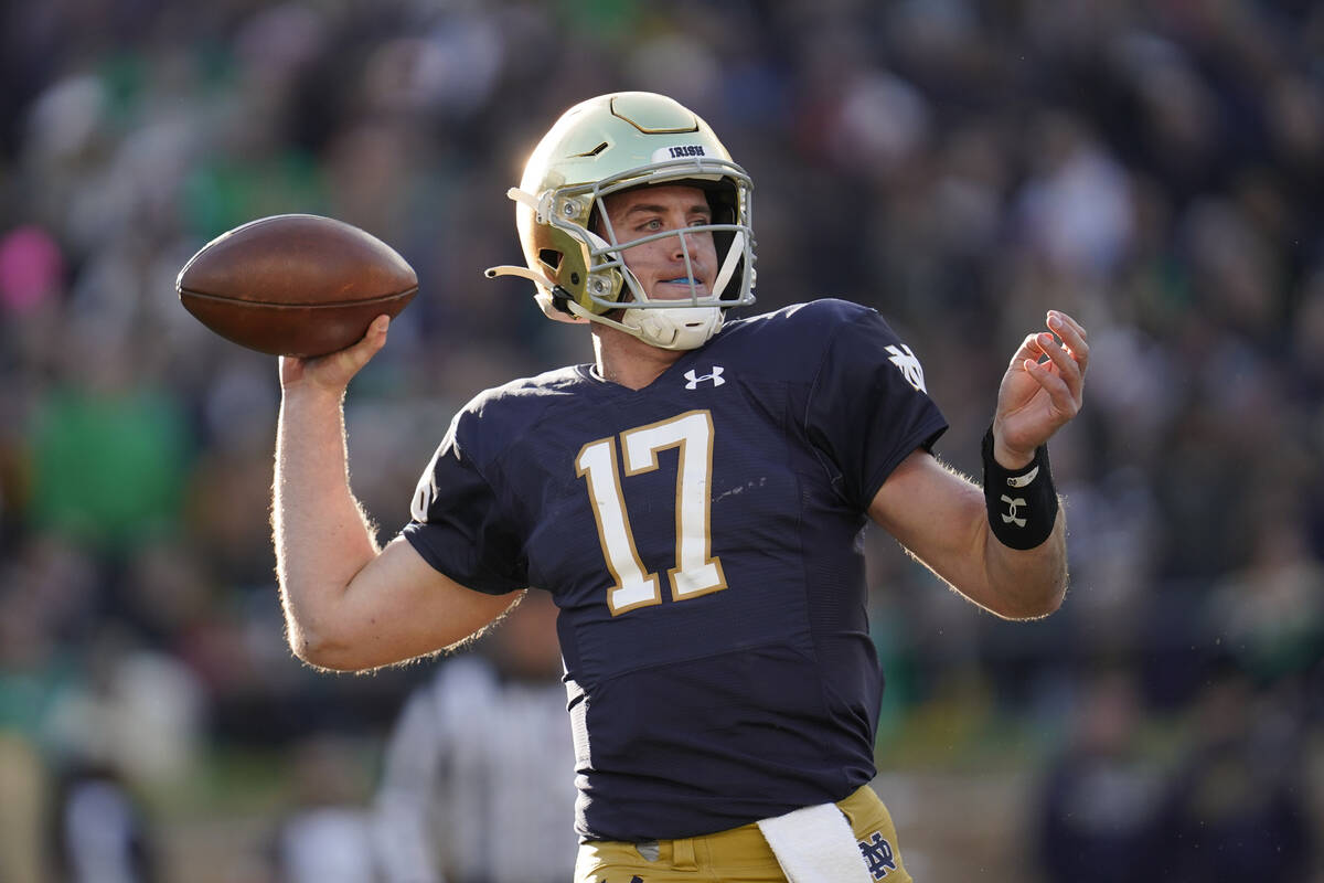 Notre Dame quarterback Jack Coan throws against Navy in the first half of an NCAA college footb ...