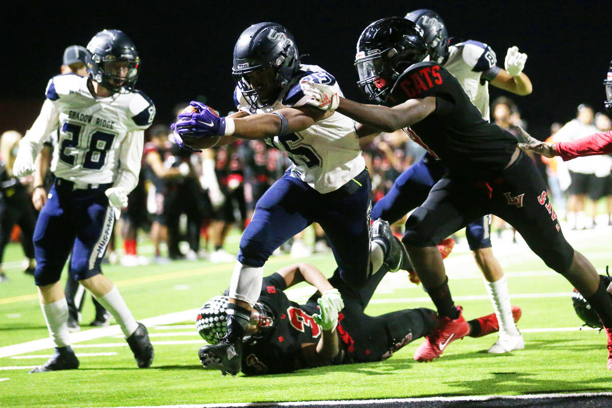 Shadow Ridge's Jaquieze Holland (25) runs the ball for a touchdown under pressure from Las Vega ...