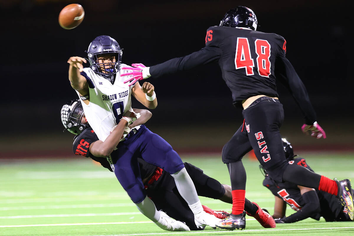 Shadow Ridge's Coen Coloma (8) throws a pass as he stacked by Las Vegas' Garrett Hughes (9) in ...