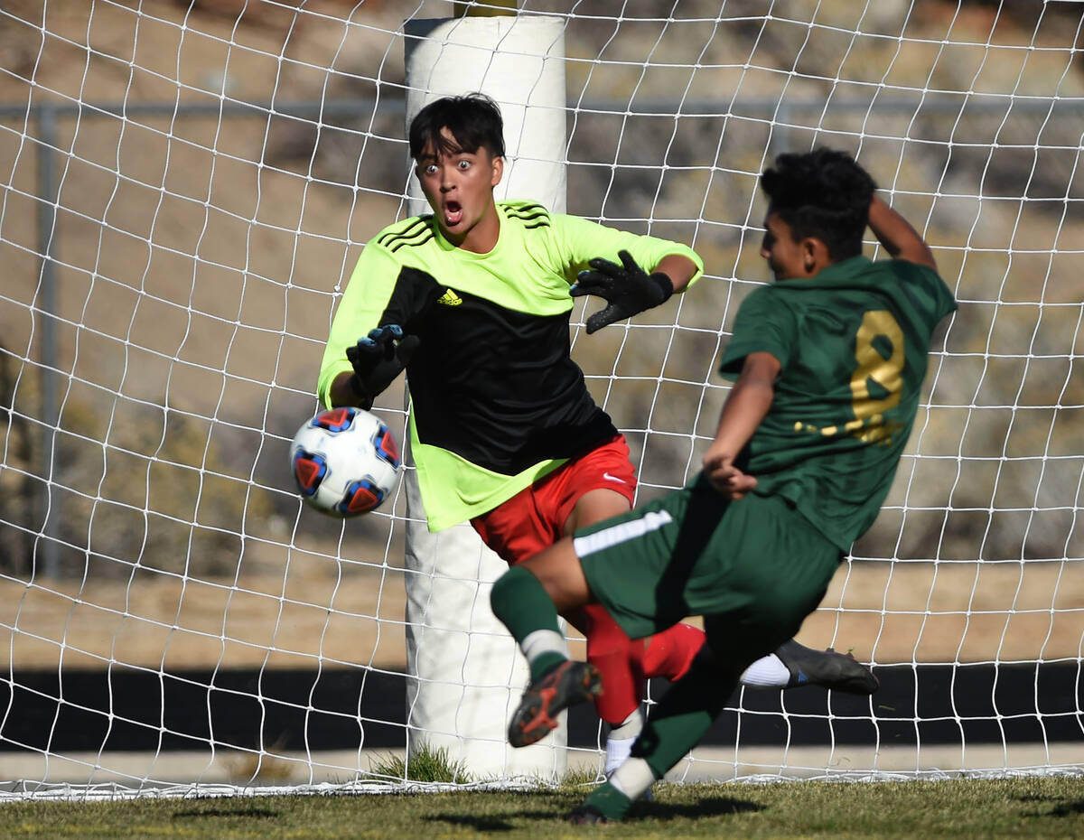 Coronado goalkeeper Finn Gustafson looks to stop a shot by Hug's Alan Gutierrez during Friday's ...