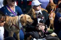 Gabriella Hatfield, right, and her dog Xoco, pose for photos during a walk in honor of Tina Tin ...