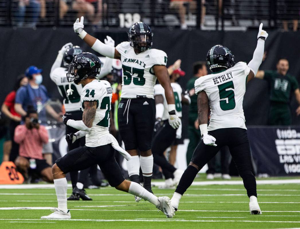 Hawaii Warriors players celebrate after wide receiver Nick Mardner (84) intercepted the ball du ...