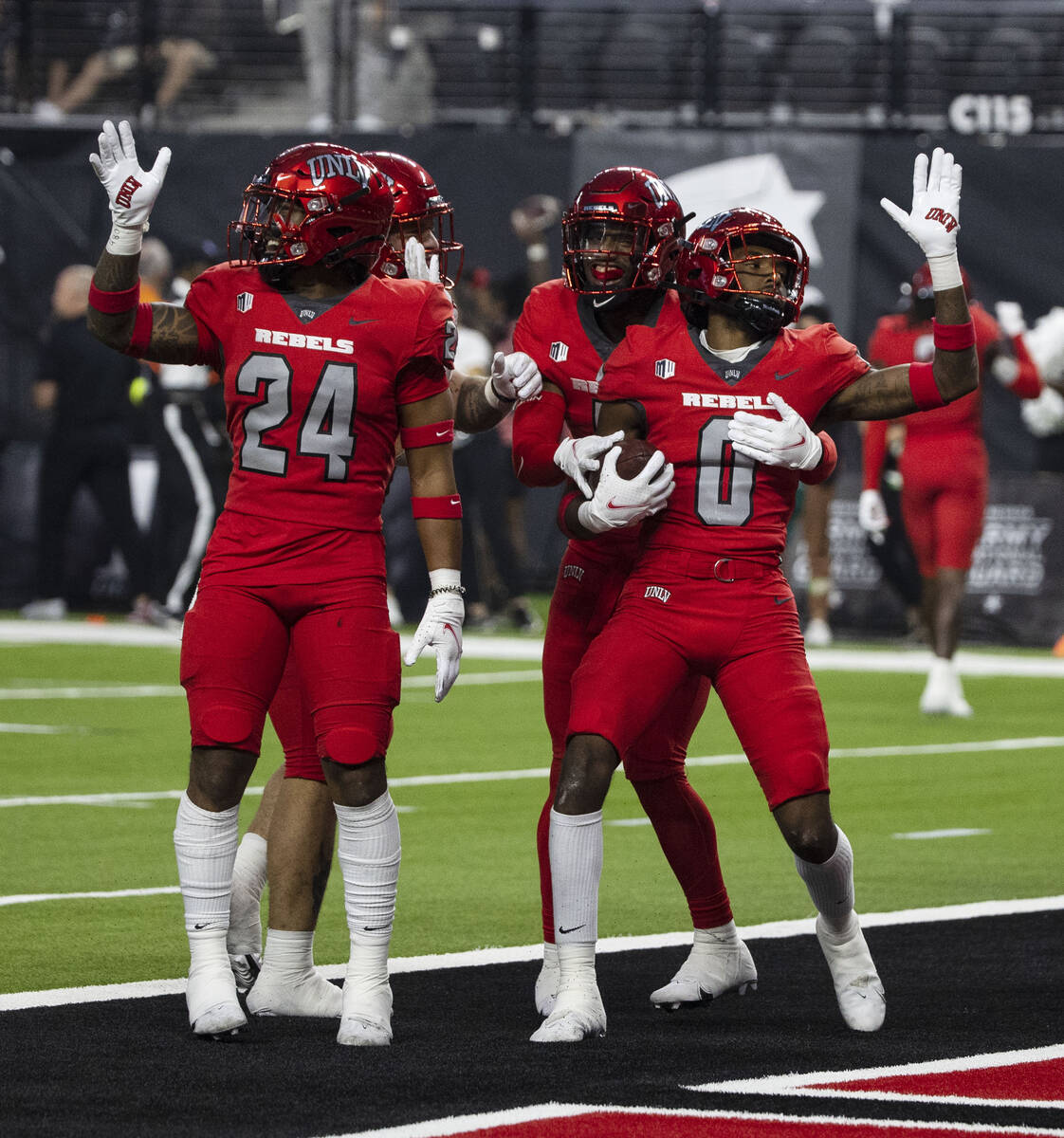 UNLV Rebels defensive back Ricky Johnson (0) celebrates with his teammates after intercepting t ...