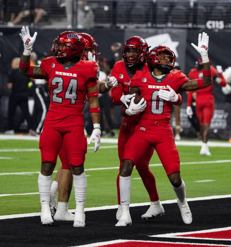 UNLV Rebels defensive back Ricky Johnson (0) celebrates with his teammates after intercepting t ...