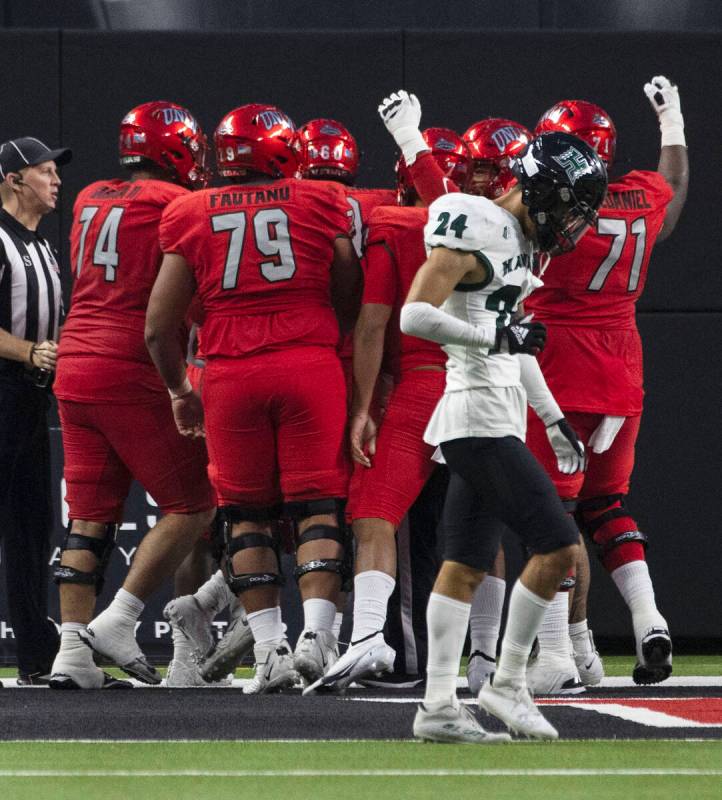 UNLV Rebels players celebrate running back Charles Williams’ (8) touchdown as Hawaii War ...
