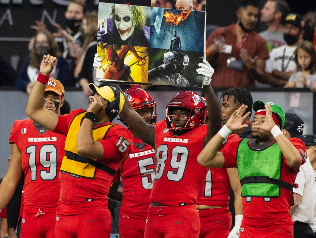UNLV Rebels players display game signs from the sideline during the second half of an NCAA foot ...