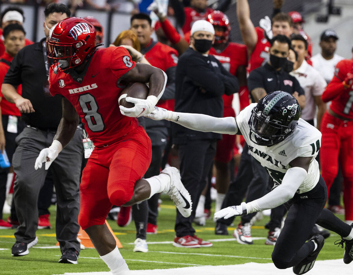 UNLV Rebels running back Charles Williams (8) is pushed out of bound by Hawaii Warriors defensi ...