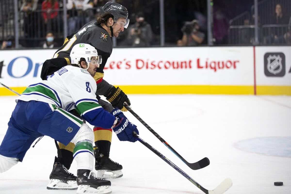 Golden Knights right wing Mark Stone (61) skates to defend while Canucks right wing Conor Garla ...