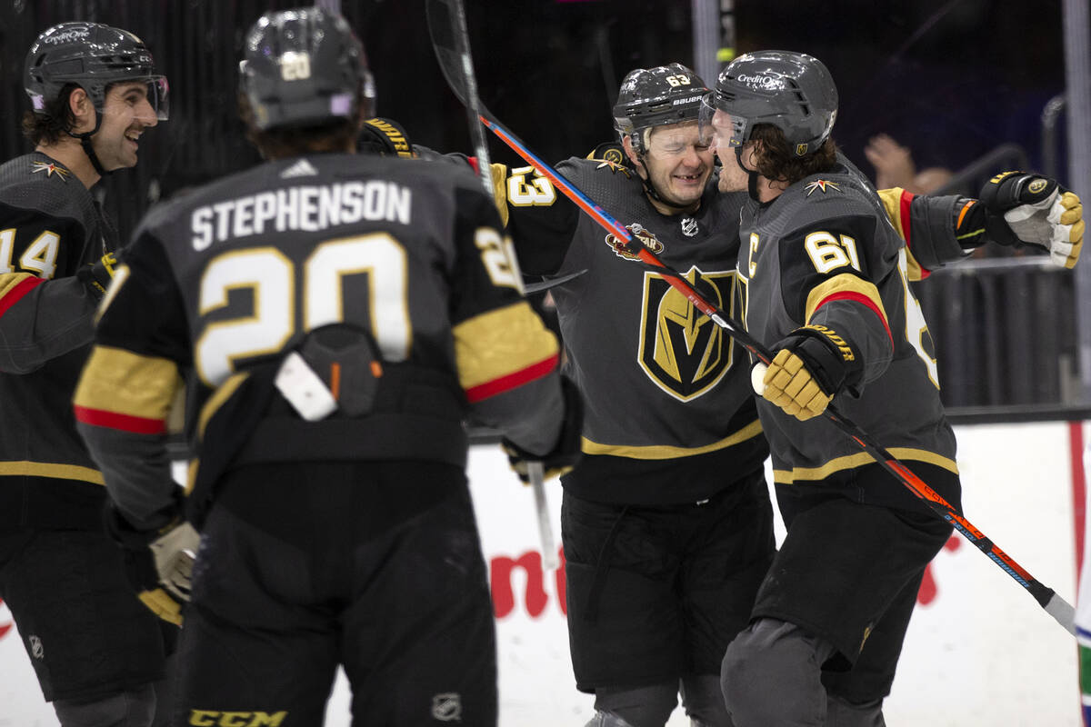 Golden Knights right wing Evgenii Dadonov (63) and right wing Mark Stone (61) celebrate a goal ...