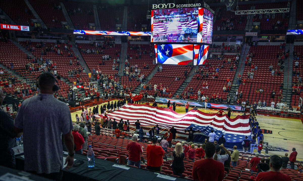 The National Anthem is sung as the American flag is unfurled before the UNLV Rebels take on the ...