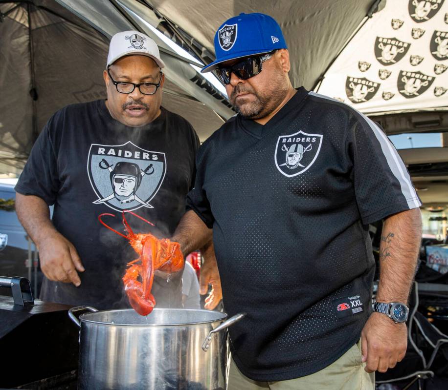 Raiders fans James Davidson, left, and Fernando Zarate of California check to see if one of the ...