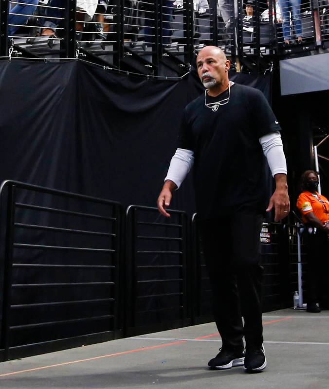 Raiders interim head coach Rich Bisaccia walks onto the field before the start of an NFL game a ...