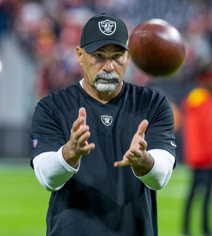Raiders interim head coach Rich Bisaccia looks in a pass before the first half of an NFL game a ...