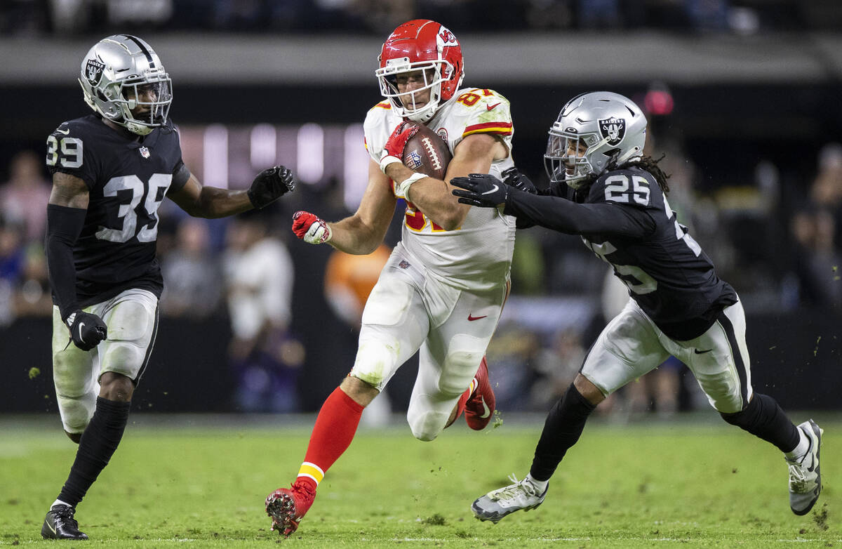 Kansas City Chiefs tight end Travis Kelce (87) breaks off a big run past Raiders cornerback Nat ...