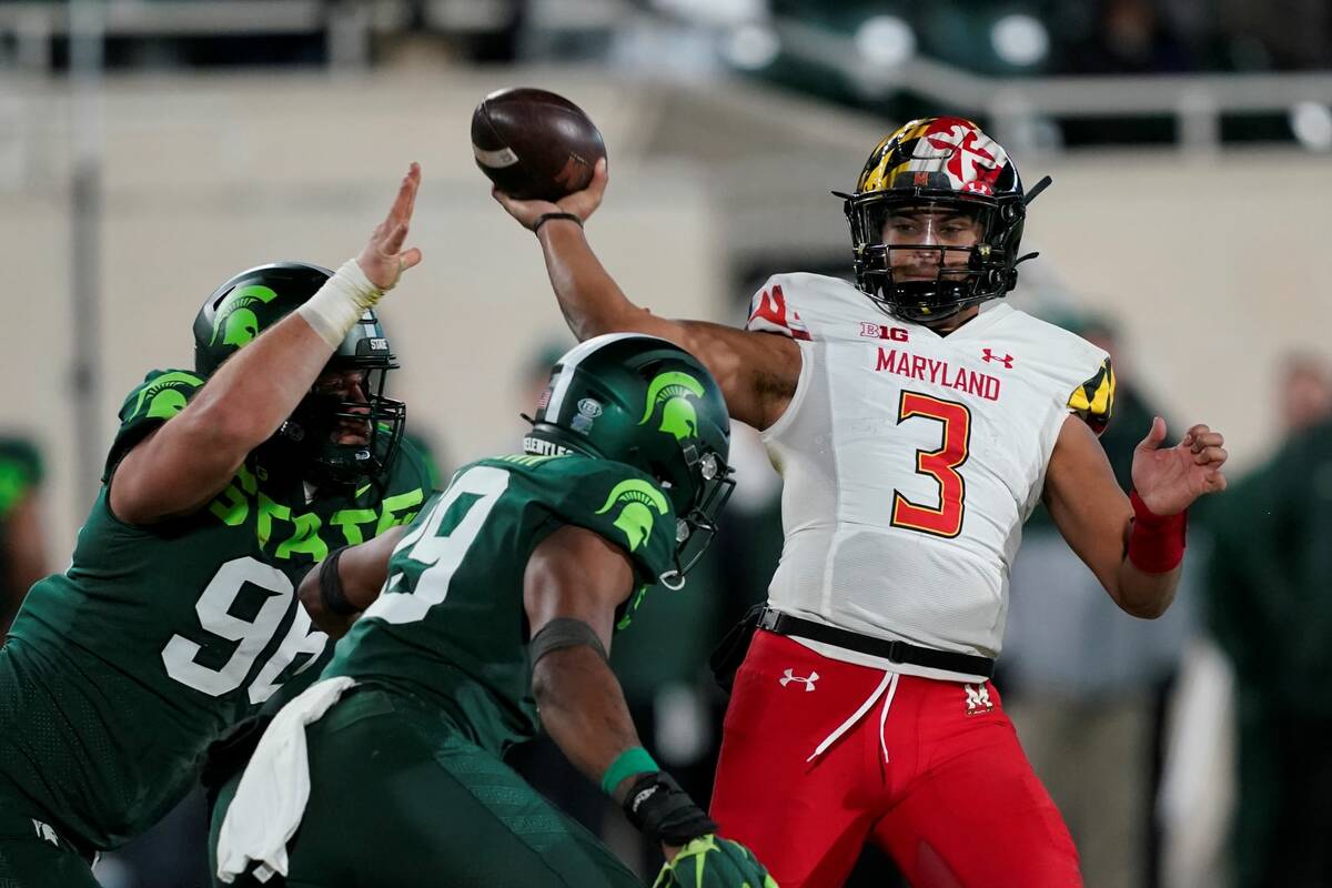 Maryland quarterback Taulia Tagovailoa (3) is pressured by Michigan State defensive end Jacub P ...