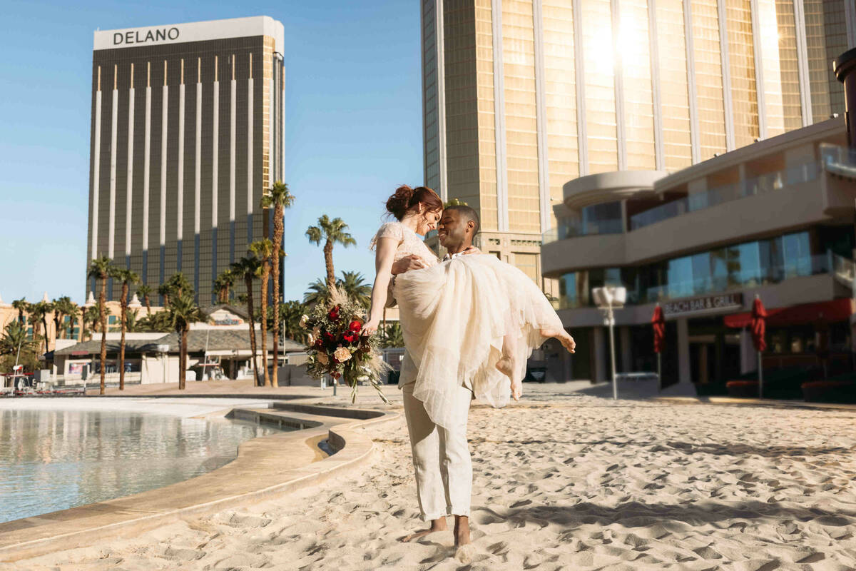 A couple on the sandy beach at Mandalay Bay is shown in this image from the LVCVA's Forever Hap ...