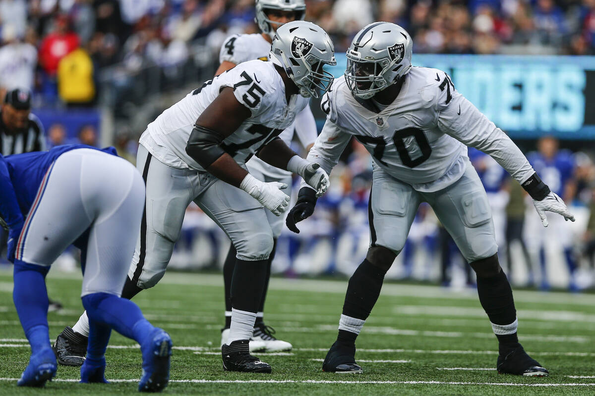 Las Vegas Raiders' Brandon Parker (75) talks to Alex Leatherwood (70) during the second half of ...