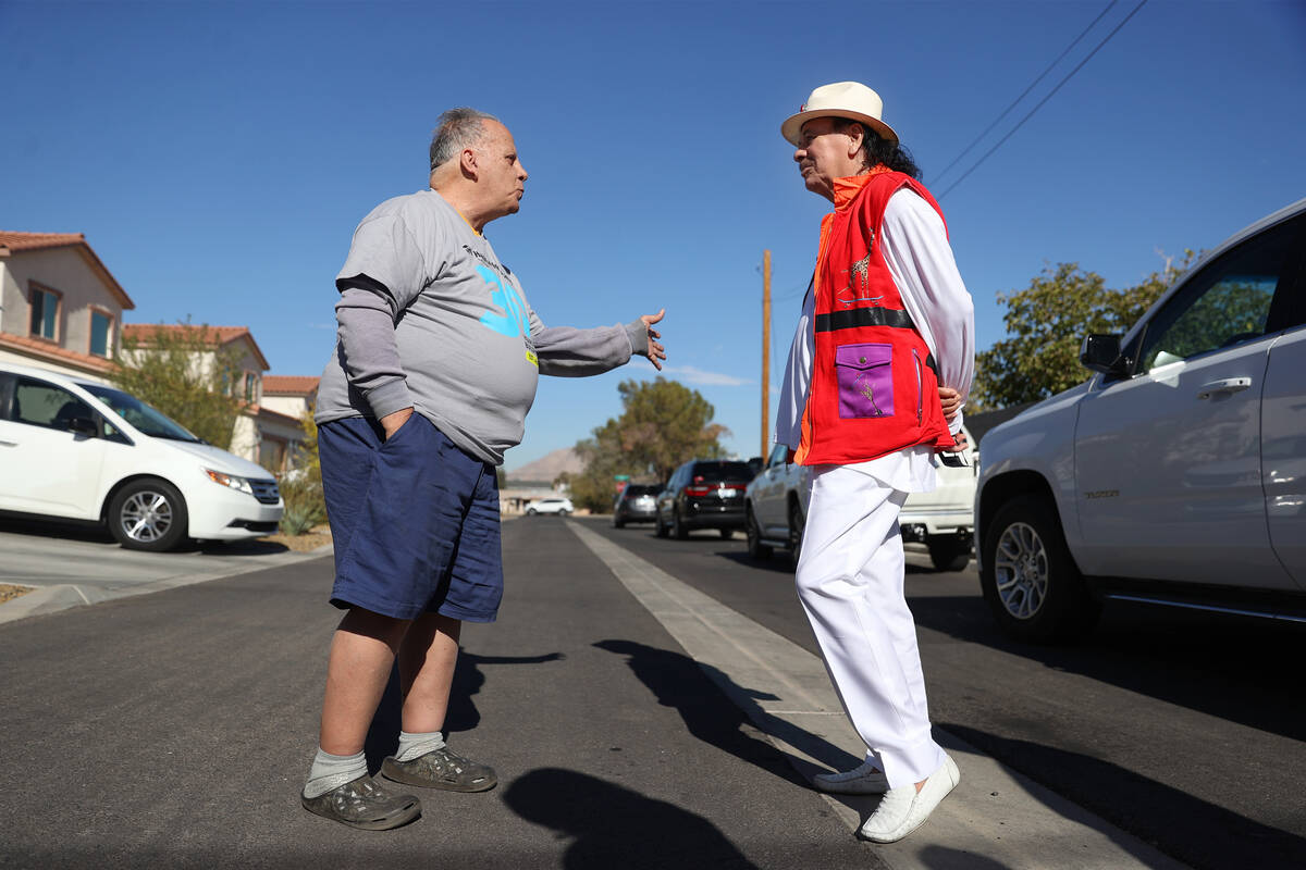 Reuben Nieves speaks to musician Carlos Santana during a Habitat for Humanity event to unveil a ...