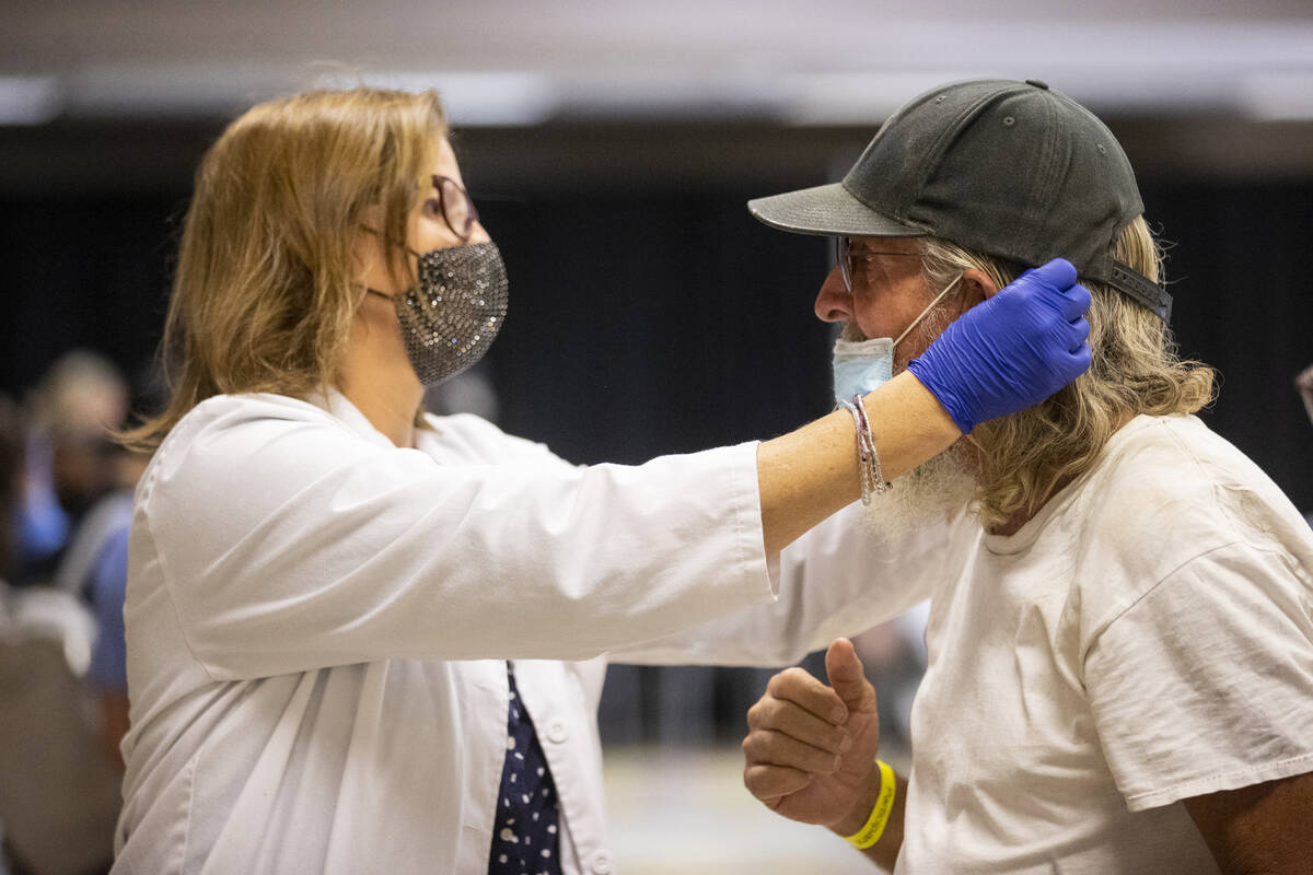 Participate Danny Geisler, right, gets matched with new glasses by College of Southern Nevada o ...