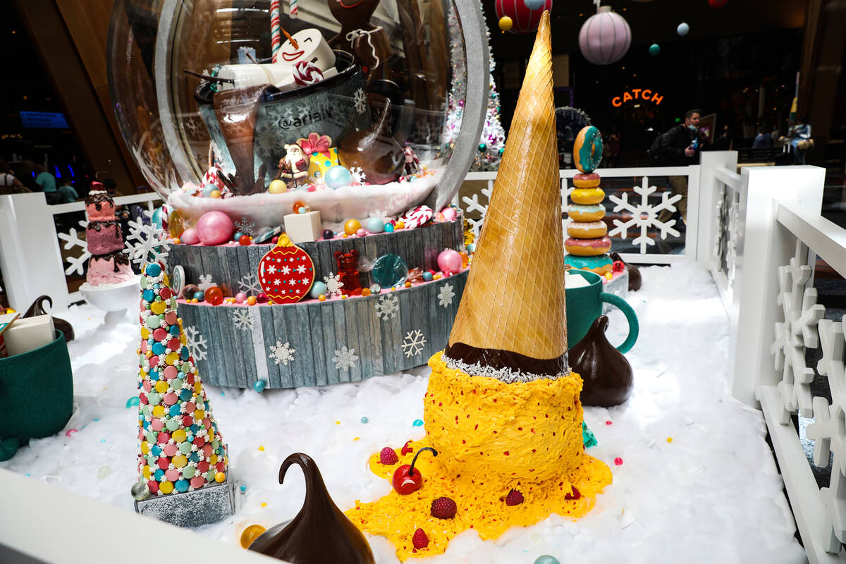 The holiday display made of mostly candy and features an 8-foot-tall snow globe created by the ...