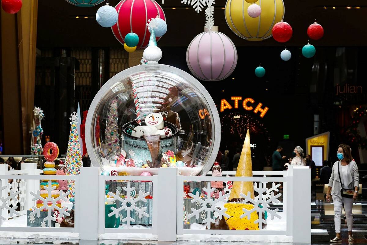 The holiday display made of mostly candy and features an 8-foot-tall snow globe created by the ...