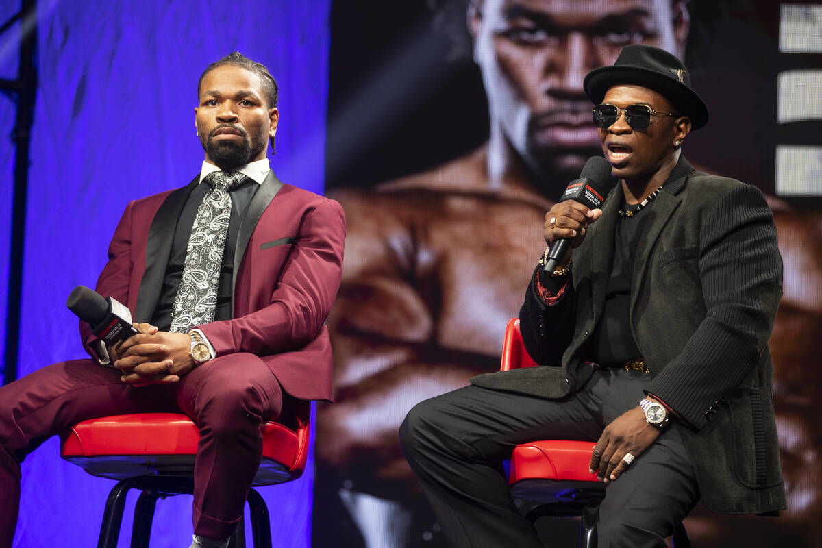 Shawn Porter, left, with his father and trainer Kenny, participate during a press conference fo ...