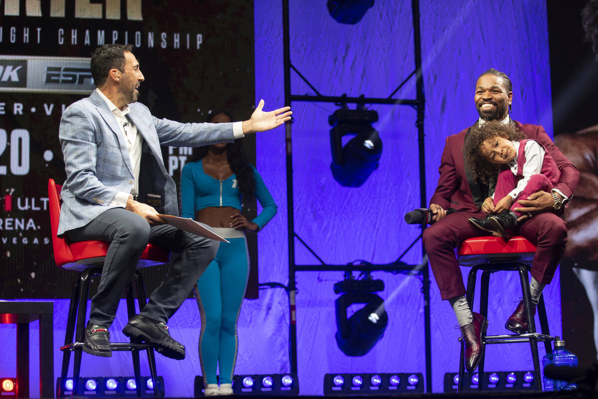 Moderator Joe Tessitore, left, speaks to Shawn Porter and his son Shaddai, 3, participate durin ...