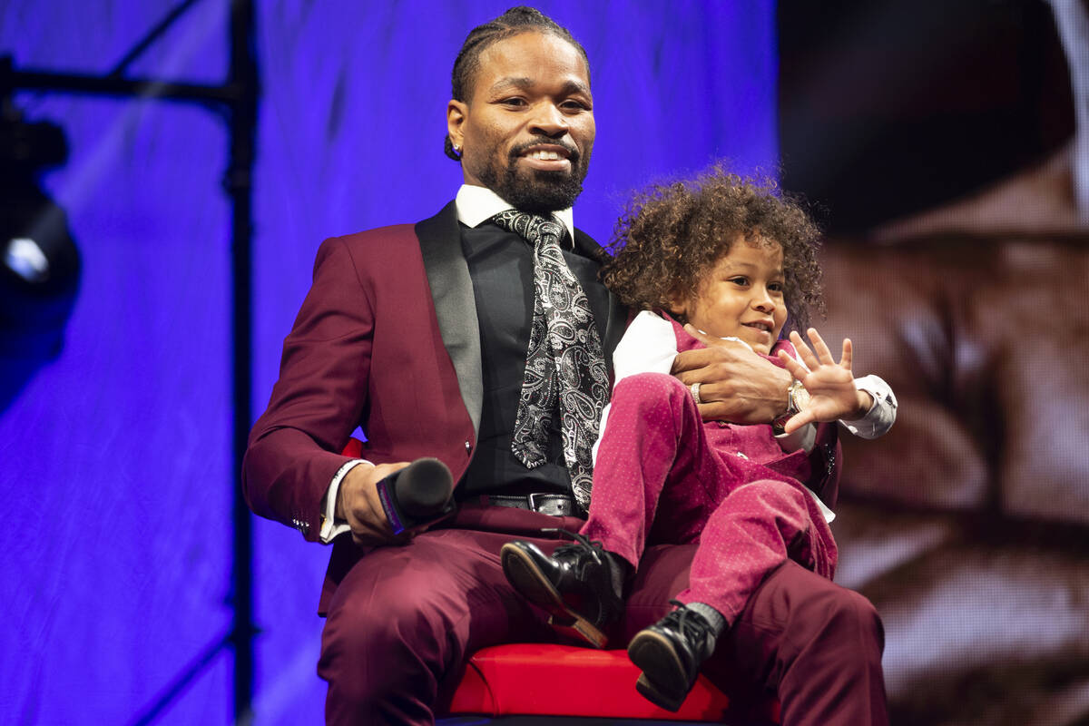 Shawn Porter and his son Shaddai, 3, participate during a press conference at the Mandalay Bay ...