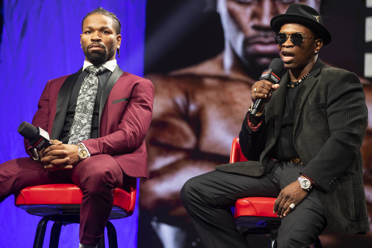 Shawn Porter, left, with his father and trainer Kenny, participate during a press conference fo ...