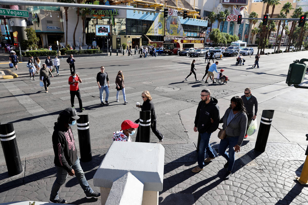 People walk between The Linq and Caesars on the Strip in Las Vegas Monday, Nov. 22, 2021. (K.M. ...