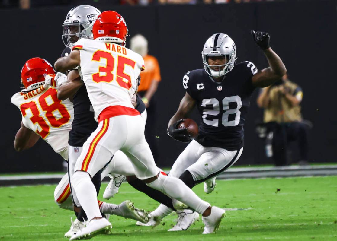 Raiders running back Josh Jacobs (28) runs the ball against the Kansas City Chiefs during the f ...