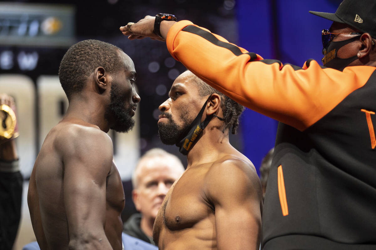 Terence Crawford, left, and Shawn Porter, center, with his father Kenny Porter, pose during a w ...