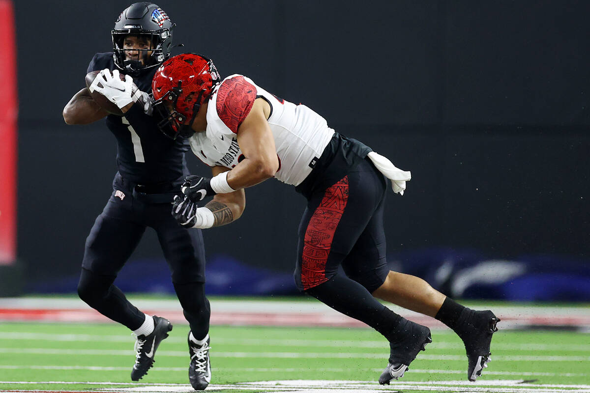UNLV Rebels wide receiver Kyle Williams (1) is tackled by San Diego State Aztecs linebacker Bra ...