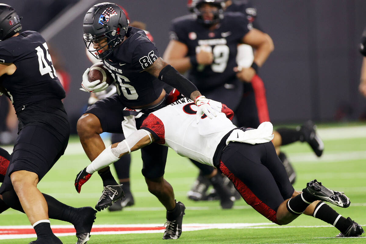 UNLV Rebels wide receiver Marcus Phillips Jr. (86) is tackled by San Diego State Aztecs cornerb ...