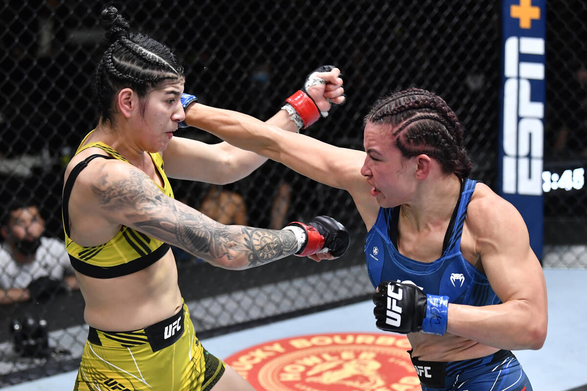 (R-L) Miesha Tate punches Ketlen Vieira of Brazil in a bantamweight fight during the UFC Fight ...