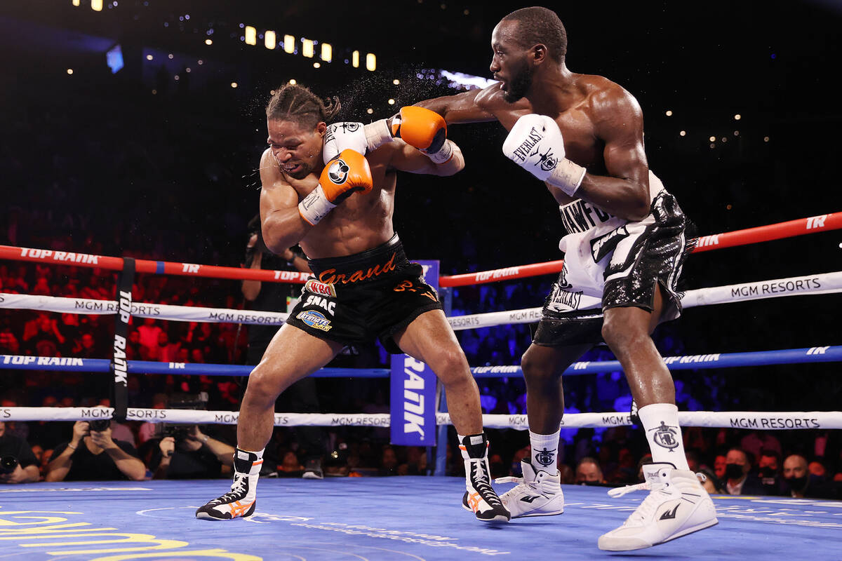 Terence Crawford, right, connects a punch against Shawn Porter in the 10th round of the WBO wel ...