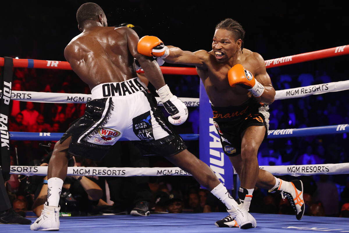 Terence Crawford, left, battles Shawn Porter in the third round of a WBO welterweight title fig ...