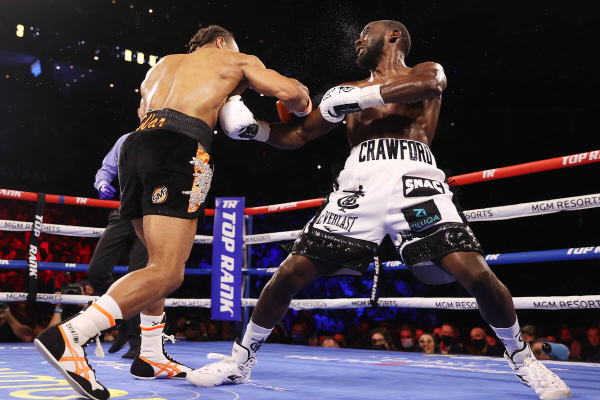 Shawn Porter, left, connects a punch against Terence Crawford in the third round of a WBO welte ...