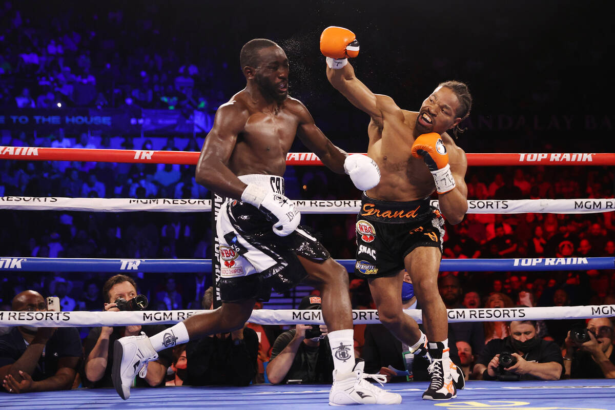 Shawn Porter, right, connects a punch against Terence Crawford in the second round of a WBO wel ...