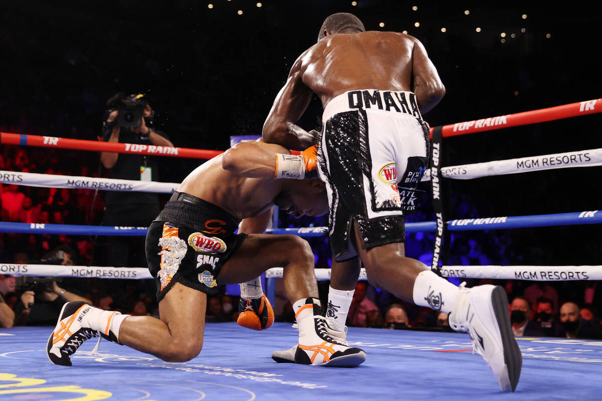 Terence Crawford, right, connects a punch against Shawn Porter to knock him down and to win by ...